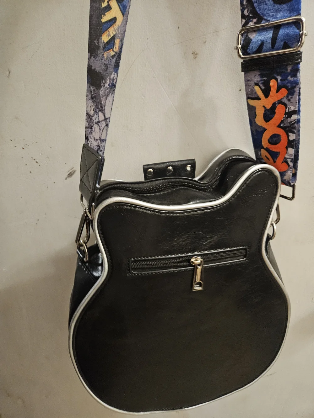 Black and Cream Guitar-Shaped Crossbody Bag with Graphic Strap